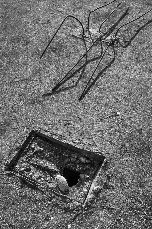 Bent rebar and square hole in concrete roof, monochrome abstract. Patara, Turkey. P.Maton 04/09/2014 eyeteeth.net