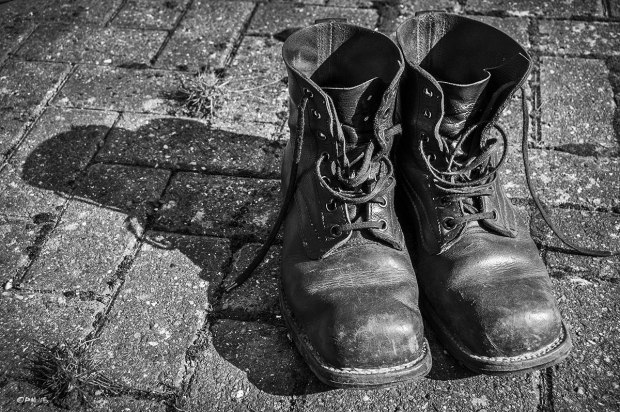 Well worn Swedish Army Boots on brick pavement. Monochrome Landscape. © P. Maton 2015 eyeteeth.net