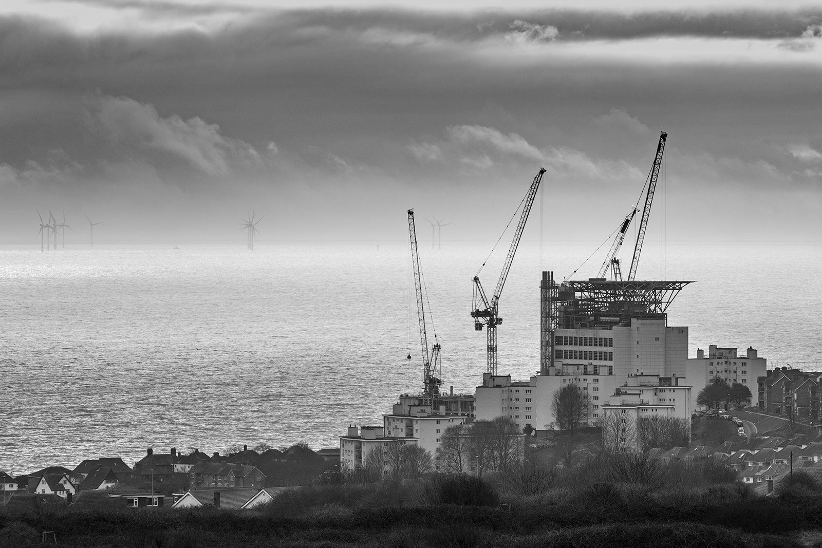 Construction work with cranes at Royal Sussex County Hospital with seascape and sky in background, black and white landscape photography Brighton Sussex UK ©P. Maton 2019 eyeteeth.net
